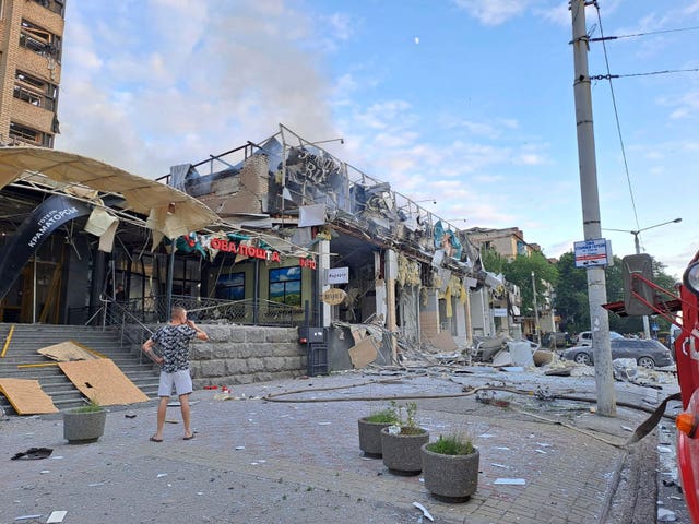 b8938ea8068d42dda706cd5b9e593dce A man stands on the street in front of the restaurant destroyed by a missile attack in Kramatorsk