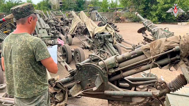 Artillery systems belonging to Russia’s Wagner military contractor are parked at an undisclosed location ahead of their handover to the Russian military
