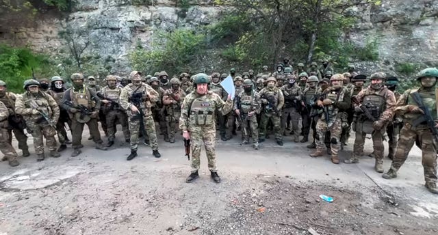 ec3b34bb84fb42708cc95ce66199ed59 In this handout image taken from a video released by Prigozhin Press Service on Friday, May 5, 2023, head of Wagner Group Yevgeny Prigozhin reads his statement standing in front of his troops in an unknown location