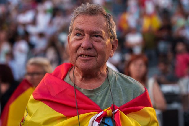 066b2ffc87a1446282773f5784dad90b A supporter of Vox far right party wrapped in a Spanish flag attends an election campaign event in Guadalajara, Spain (Manu Fernandez/AP)