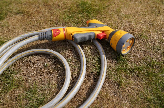 2-68169486 A hosepipe lies on a patch of scorched grass in Basingstoke, Hampshire