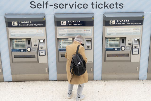 2-71245440 A person using a ticket machine