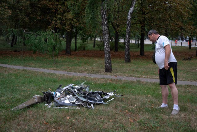 20cc3a32f77040ae9419e7fa3579ab83 Someone looks at a rocket fragment