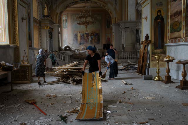 35d0b0c00a29499a9ff57b29e890d24c People clean up inside the Odesa Transfiguration Cathedral