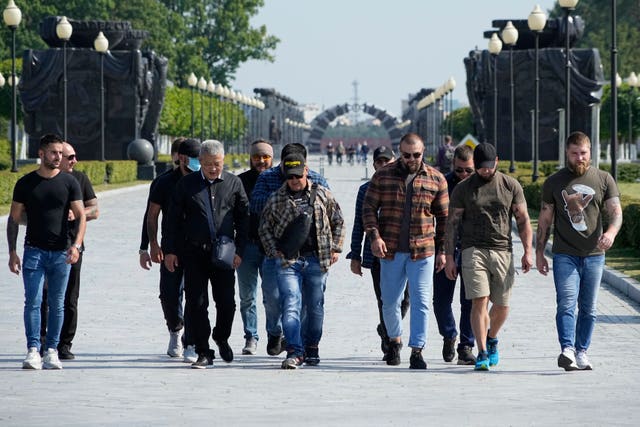 5064c5f7a8584c529688a78c860f7ad5 Colleagues of Dmitry Utkin, who oversaw the Wagner Group’s military operations, walk after a farewell ceremony for him at the Federal Military Memorial Cemetery in Mytishchy, outside Moscow, Russia