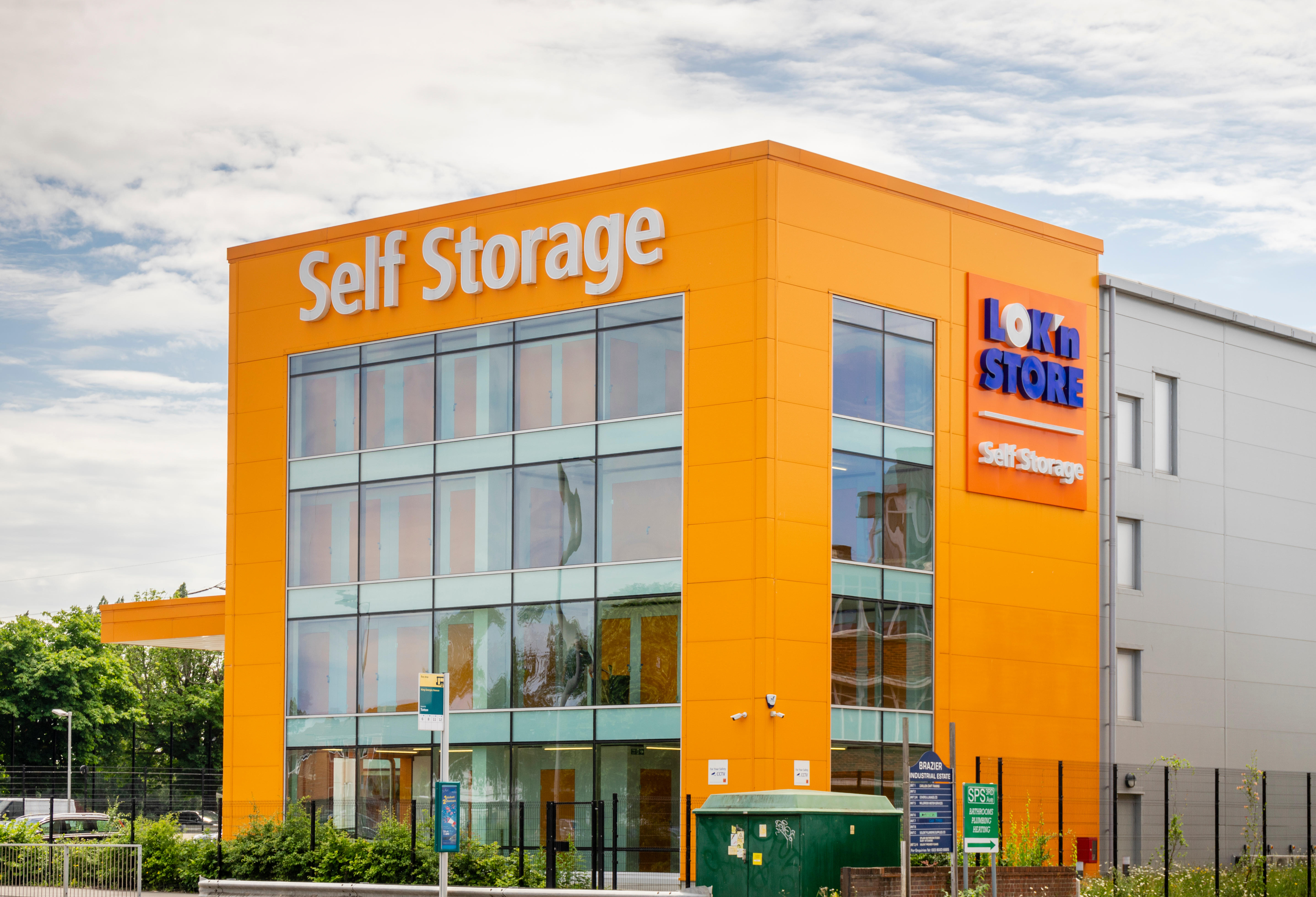 553f6936-1726-4bd6-b9bb-22c09517f8fe Orange coloured building facade of a Lok'nStore self age unit in Southampton, England, UK