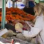 A woman checks the price of a water melon in Essen, Germany