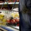 Person holding basket of goods in a supermarket