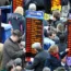 Bookmakers ply their trade as racegoers gather around to place bets