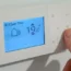 A home thermostat being used