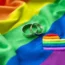 Two wedding rings on a rainbow flag
