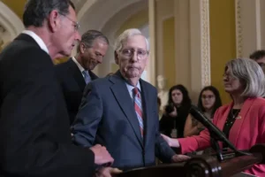 Mitch McConnell helped away from cameras after freezing during press conference
