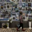 A girl looks at photographs, of Ukrainian soldiers killed in the country’s war against Russia, at the Wall of Remembrance in Kyiv