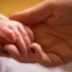 A mother holding a baby's hand