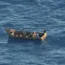 Four migrants in a small boat