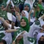 Students wave national flags to commemorate Pakistan's Independence Day