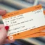 A woman holding train tickets