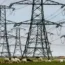 Overhead power cables from the Dungeness Nuclear Power Station stretching across the Kent countryside