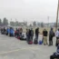 People without vehicles line up to register for a flight to Calgary, Alberta, in Yellowknife