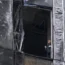 An investigator examines damage to a skyscraper in the Moscow City business district
