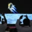 Journalists film the live telecast of India's Chandrayaan-3 spacecraft landing on the Moon