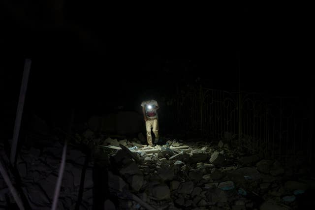 6512faa23cbf436bb974a7764e0f71fe A resident walks through the rubble of an apartment building destroyed in Russian missile attacks in Odesa