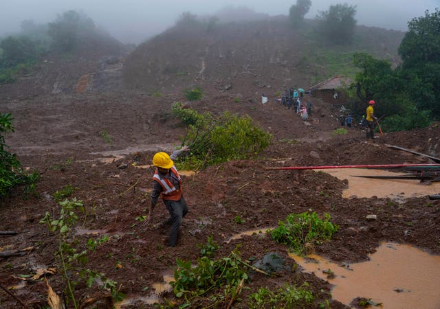 65d57d19e9cd42698a2c32dc0c2e633d A rescue worker’s feet is stuck in mud at the site of a landslide (Rafiq Maqbool/AP)