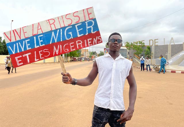 68ceccdcbc41441397a2c4f0bd680134 A supporter of Niger’s ruling junta holds a placard in the colors of the Russian flag reading “Long Live Russia, Long Live Niger and Nigeriens” at the start of a protest called to fight for the country’s freedom and push back against foreign interference in Niamey, Niger