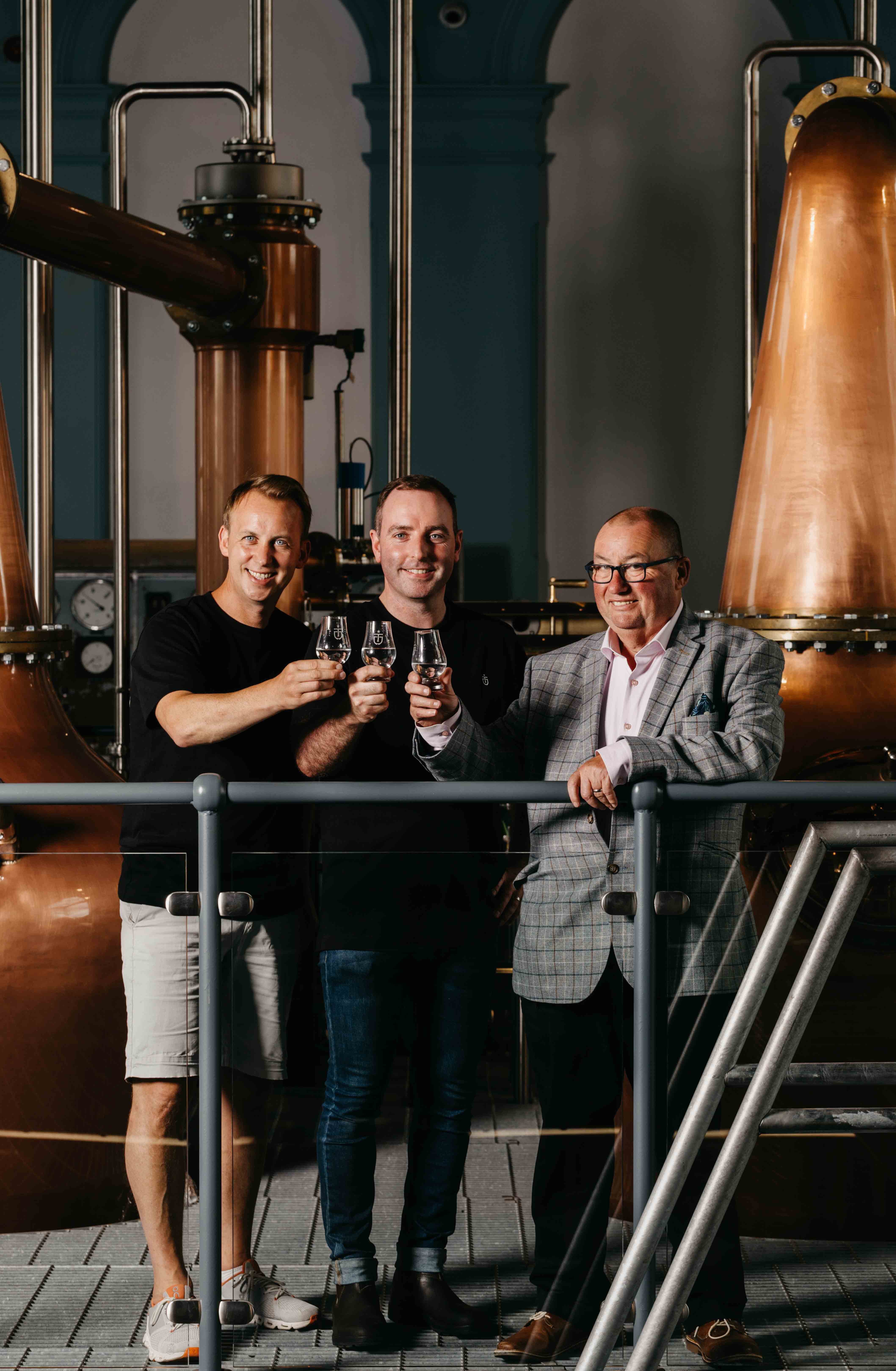 Titanic Distillers directors Stephen Symington, left, and Peter Lavery, right, with head distiller Damien Rafferty