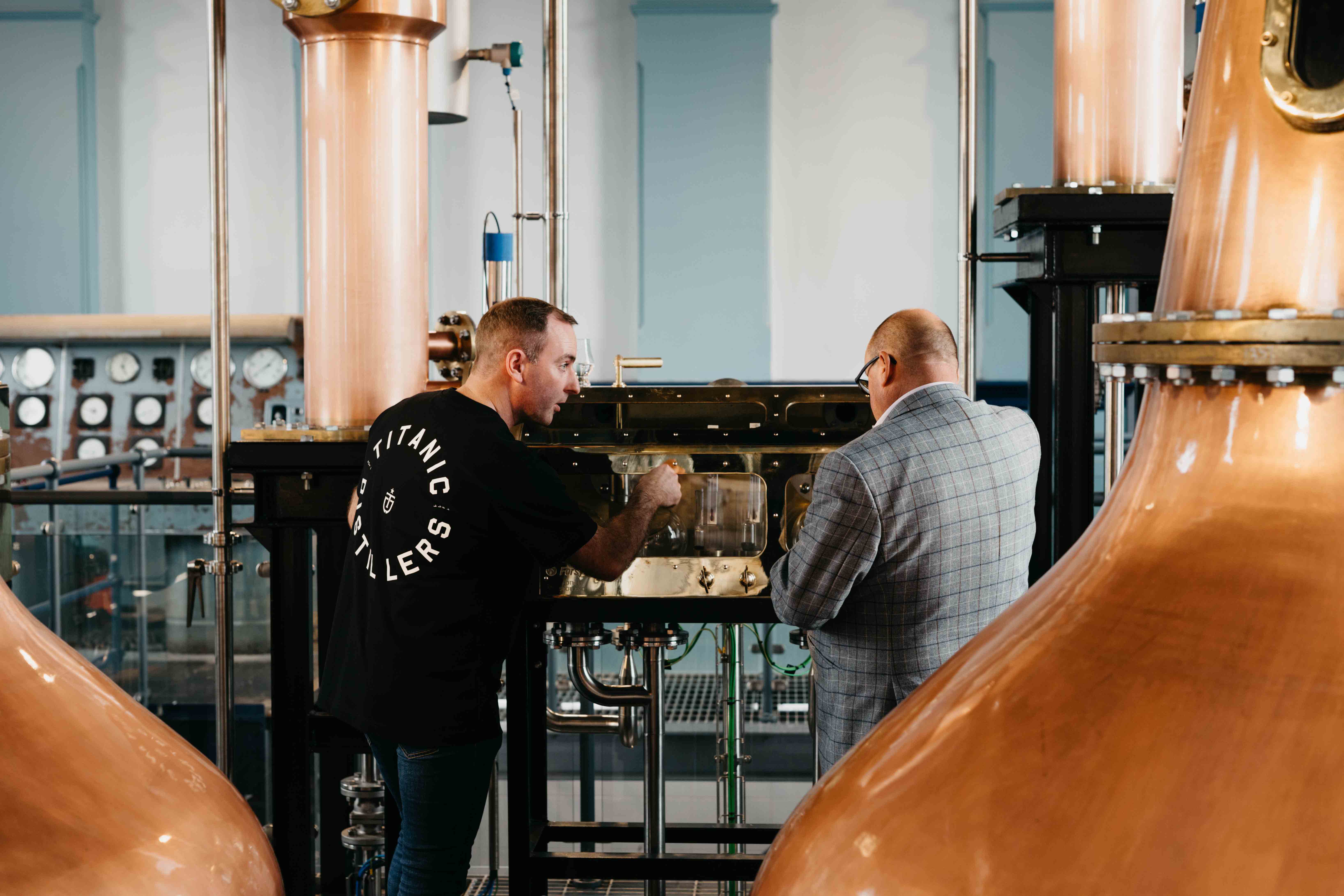 Titanic Distillers director Peter Lavery (right) discusses the whiskey-making process with Head Distiller Damien Rafferty as production started at Belfast’s first working whiskey distillery since the days of prohibition in the 1930s. Titanic Distillers, located on the site of the historic Thompson Dock and Pumphouse in the heart of the city’s Titanic Quarter, was granted its Distillers License to produce spirits last week, and the shiny new copper stills are now up and firing at the distillery as whiskey production got under way in Belfast for the first time in almost 90 years.