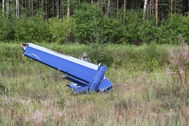 b8429b15ec1240b28848596b438ddda6-1 A Russian serviceman inspects part of a crashed private jet near the village of Kuzhenkino, Tver region, Russia