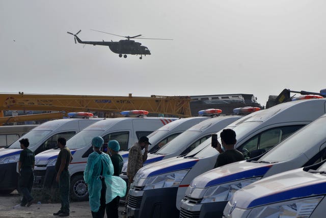 cf209410b8404dfb96b947367183f2b6 helicopter takes off and medical workers stand by ambulances