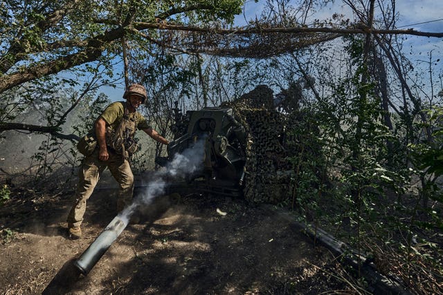 d73e0e30259c4ce9a659e736c7cb75a6 A Ukrainian serviceman fires a cannon towards Russian positions at the front line in Donetsk