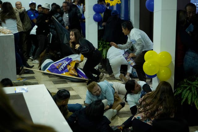d8af165429b84b55bbbebcb30f343202-1 Supporters of presidential candidate Fernando Villavicencio run for cover after he was shot to death