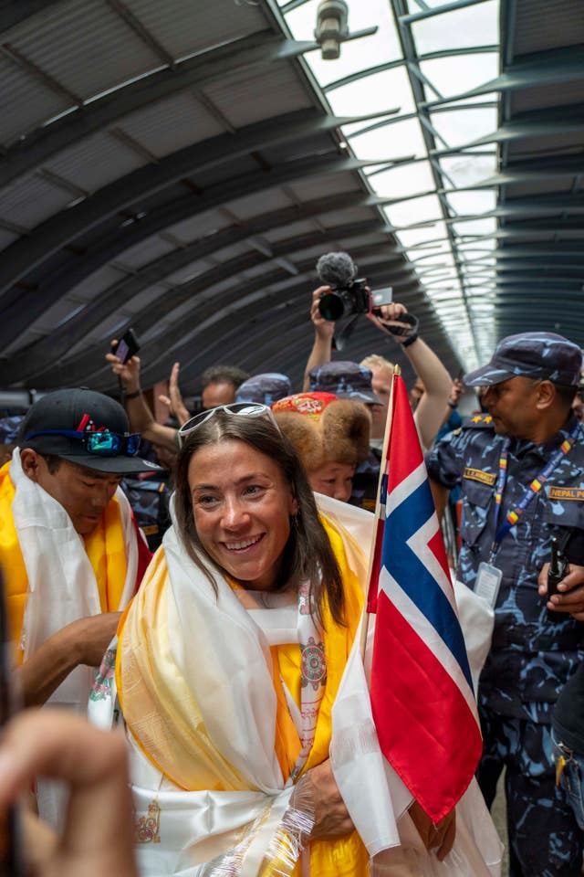 fbf07bbfd27a4815ac0b4965e0dc1416 Norwegian woman mountain climber Kristin Harila, centre, who on Thursday set a new record by scaling the world’s 14 highest peaks in 92 days smiles as she and her Nepali Sherpa guide Tenjen Sherpa, arrive at the airport in Kathmandu, Nepal