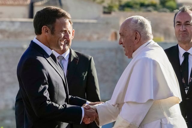 267973194b164b54b772242b821a7a8b Pope Francis is welcomed by French President Emmanuel Macron as he arrives at the final session of the Rencontres Mediterraneennes meeting at the Palais du Pharo in Marseille, France