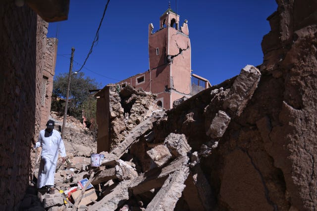 3e7452836f70427a81606a4ee661c6f3 A man walks amid the rubble in front of a damaged mosque in Moulay Brahim in the province of Al Haouz