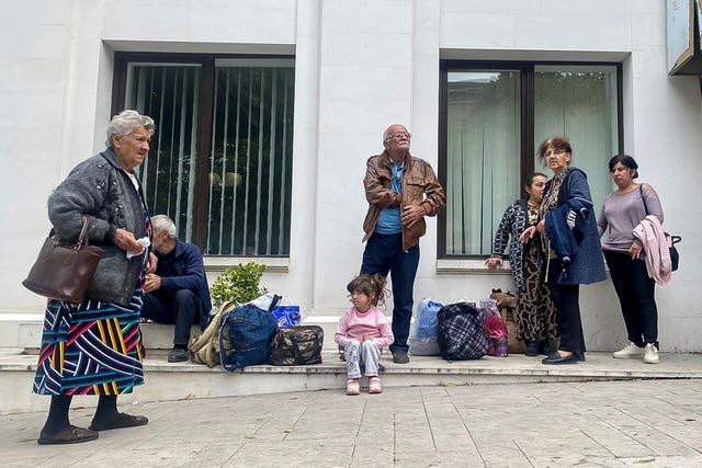 4a02eed0a6ce4b72bb3aa3c96bbe69f3 Local residents gather near a local government building after reports of shooting in Stepanakert