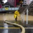 A worker pumps out floodwater