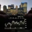 Shares graph on a phone in front of London skyline