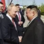 Vladimir Putin and Kim Jong Un shake hands