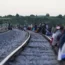 Migrants wait along rail lines in Mexico