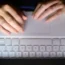 A woman's hands on a laptop