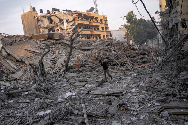 08dca6e1be7a49b2952ff288324c3e70 Palestinians inspect the rubble of a building after it was struck by an Israeli airstrike in Gaza City
