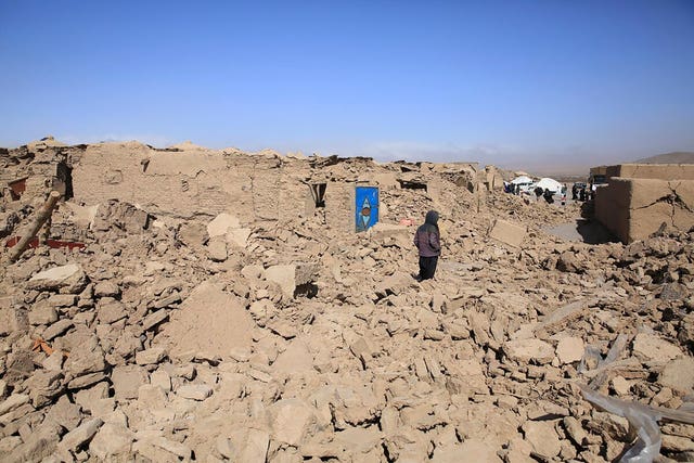 1e2d4e44bbeb40668b753ae721bf945a An Afghan boy stands amid the debris following the earthquake in Herat province