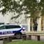 Police officers stand guard outside the school