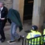 Andrew Miller (covered) being led from Selkirk Sheriff Court following an earlier hearing.