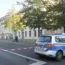 Police officers stand guard in front of the building complex of the Kahal Adass Jisroel community, which houses a synagogue, a children's nursery and a community centre, in Berlin on Wednesday
