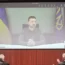 Volodymyr Zelensky on a video screen