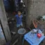 Small boy standing in ruins